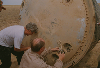 Technicians deactivating the explosives on grounded Soyuz